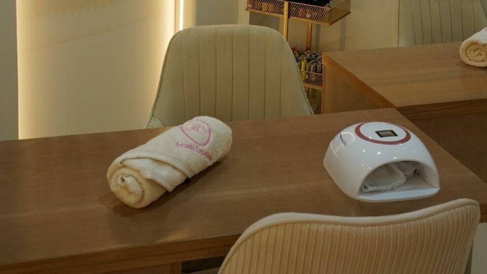 Manicure table with nail lamp and fresh towel